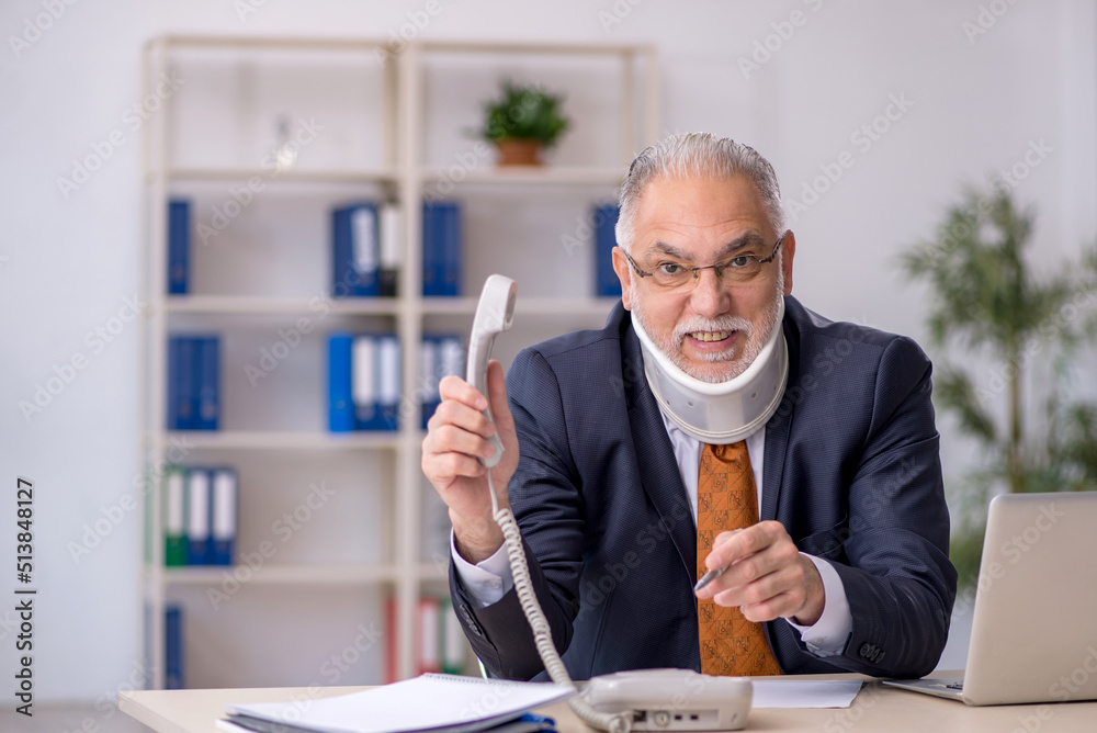 Old male employee after accident at workplace Old male employee after accident at workplace