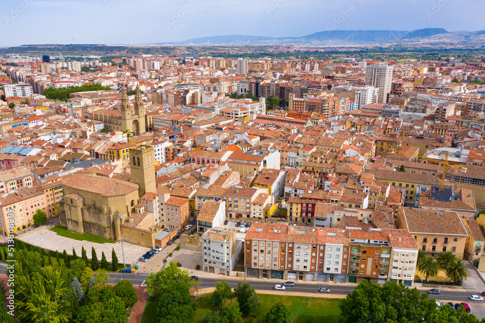 Aerial view of Logrono cityscape on banks of Ebro river overlooking spires of Co-cathedral of Santa Maria in summer day, Spain..