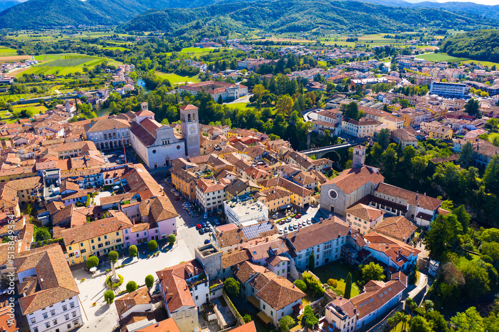 Aerial view of Cividale del Friuli cityscape on banks of Natisone river overlooking Catholic cathedral and ancient bridge Ponte del Diavolo, Italy..