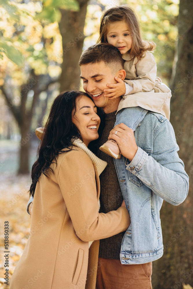 Fototapeta premium Happy young family spending time together in autumn park