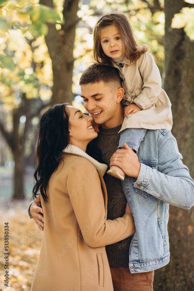 Happy young family spending time together in autumn park Happy young family spending time together in autumn park