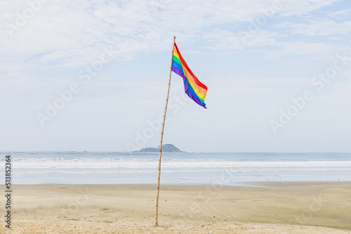 Bandeira LGBT balançando com o vento na praia photo