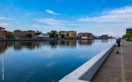 Beutiful buildings reflection on Ravenna's darsena on a morning sunny day . a dock is an enclosed area of water used for loading, unloading, building or repairing ships. Emilia-Romagna tourism