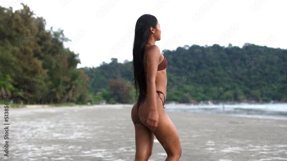 Beautiful Young Woman In Tiny Bikini Walking Into Sea