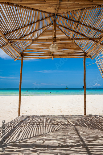 Fototapeta Naklejka Na Ścianę i Meble -  beach hut in white sands and turqoise blue waters  of Boracay beach in Philippines during summer