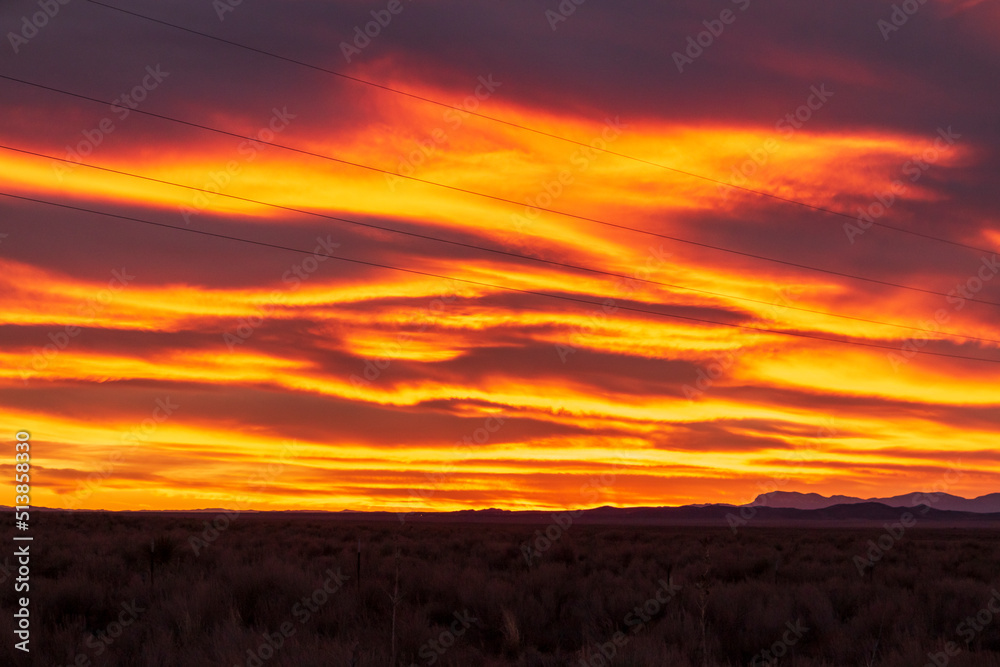 red ,fiery dramatic sky during sunset in New Mexico .