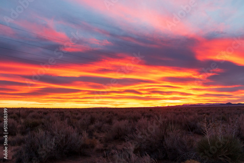 Fototapeta Naklejka Na Ścianę i Meble -  red ,fiery dramatic sky during sunset in New Mexico .