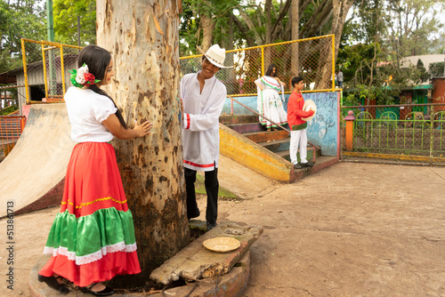 Nicaraguan teenagers dressed in typical costume of the culture of Latin America having a good time in an outdoor park