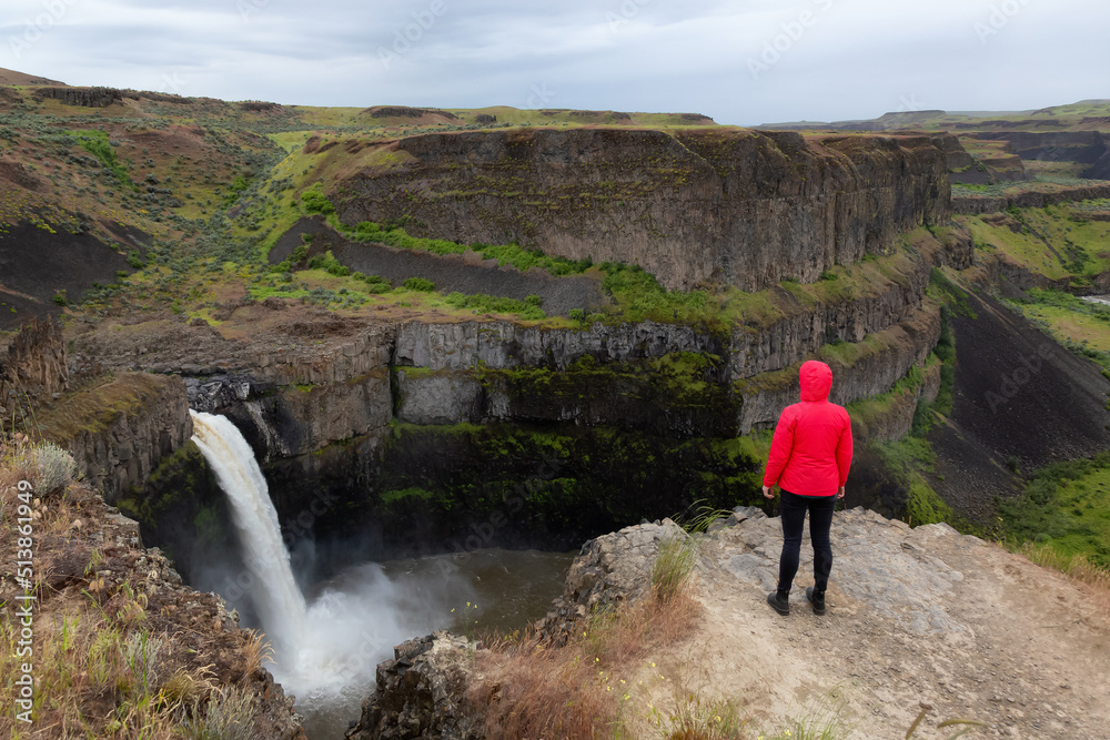 Woman Hiker at Waterfall in the American Mountain Landscape. Spring Season. Palouse Falls State Park, Washington, USA. Adventure Travel Concept