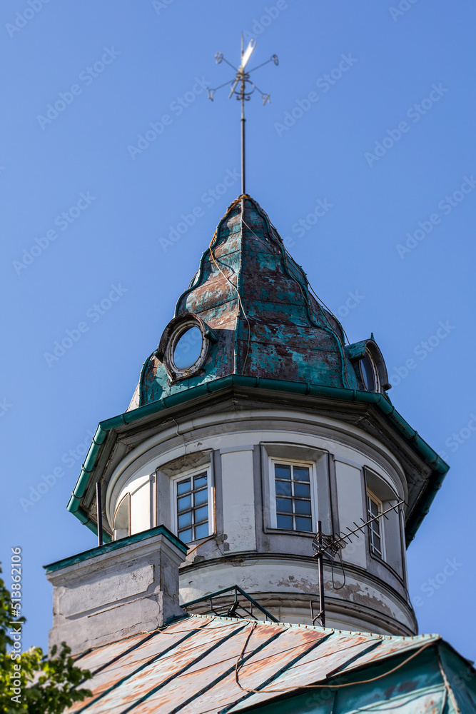 Old style roof tower with wind indicator.