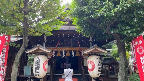 a lady praying at the alter of Japanese shrine, “Hanazono Jinjya” at Ueno Tokyo Japan, a tiny Shinto house on a little hill with beautiful nostalgia and atmosphere.  Year 2022 June 23rd photo
