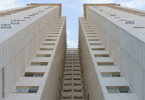 Facade of a residential building seen from below forming a symmetry