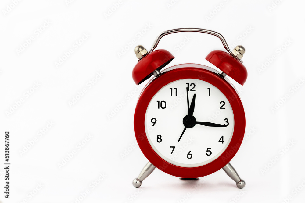 Red retro alarm clock on a white background. Red retro alarm clock on a white background.