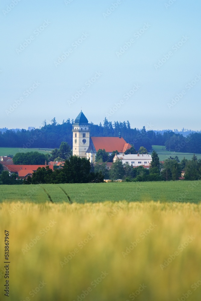 Naklejka premium Summer panoramic view of czech (Souht Bohemia) landscape with town Dacice (Dačice), fields, hills, meadow and path during sunset and mist, noise