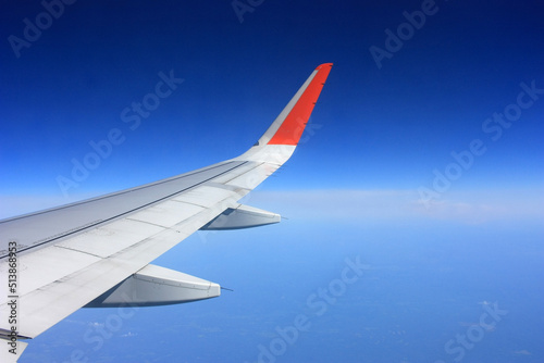 Airplane flies in the blue sky