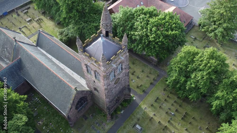Aerial view above rural English town woodland countryside idyllic church rooftop and graveyard Aerial view above rural English town woodland countryside idyllic church rooftop and graveyard