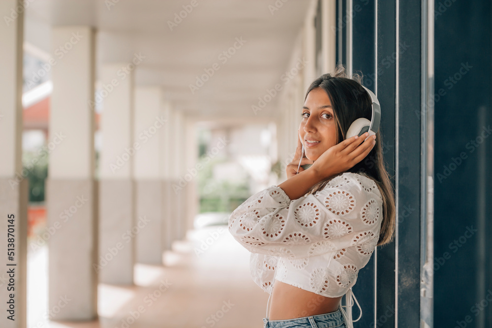 young girl with headphones on the street