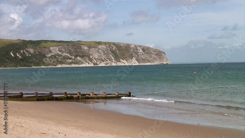 Sandy beach and white cliffs at Swanage Bay in the coastal town of Swanage in the county of Dorset in England photo