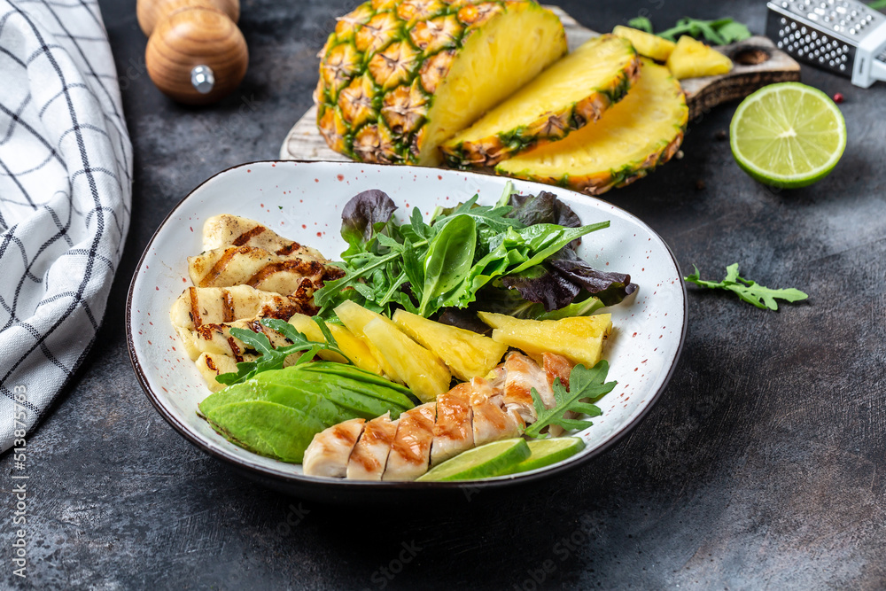Grilled chicken breast, pineapple, avocado, green rocket salad, lime and olive oil. Healthy juicy food. banner, menu recipe place for text, top view
