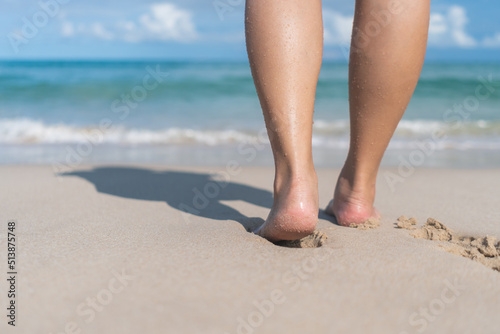 Summer vacation concept barefoot on sand at beach with copyspace.