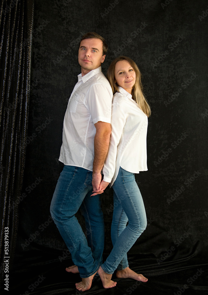 portrait of a happy couple in studio on black background portrait of a happy couple in studio on black background