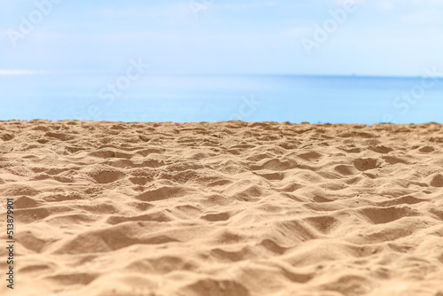 Closeup sandy beach with sea background  Tropical summer beach background  outdoor day light  empty clean fine sandy beach