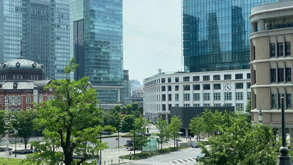 Fototapeta premium Street view of Tokyo station from above, bird view of the station and the crossings with Marunouchi / KITTE, high-rise skyscrapers, year 2022 June 19th, Japan