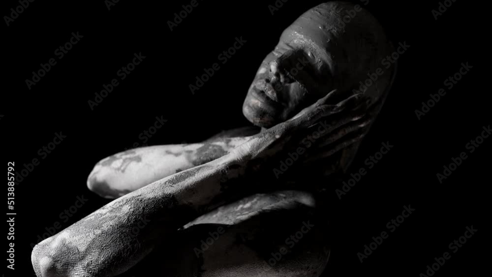 a portrait of a woman with blindfolded eyes and a face smeared with clay. she stands sideways and touches cheeks. close-up. black and white video a portrait of a woman with blindfolded eyes and a face smeared with clay. she stands sideways and touches cheeks. close-up. black and white video