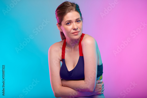 Woman with abdominal pain and digestive disorder. Female fitness portrait isolated on neon multicolor background.