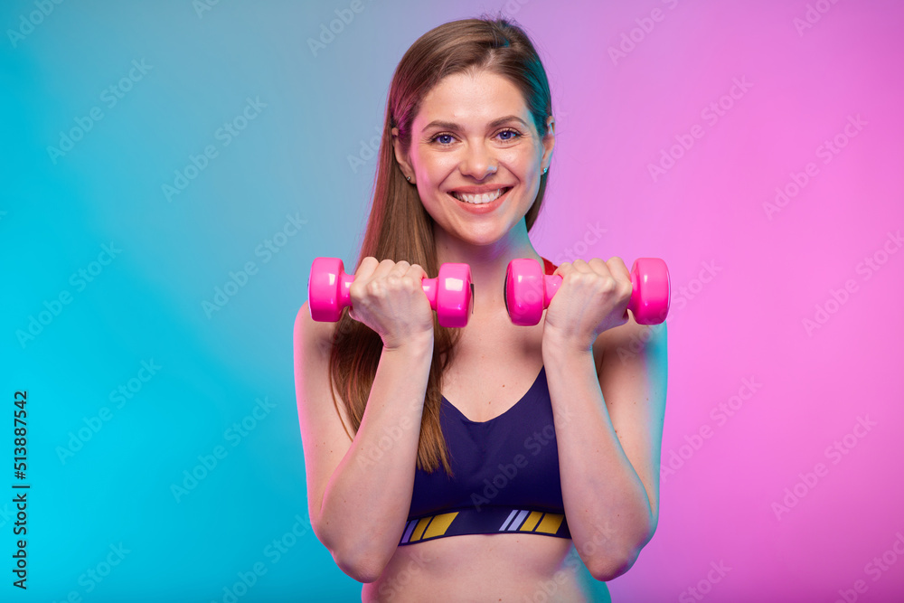 sporty woman with pink dumbbells. Female fitness portrait isolated on neon color background. sporty woman with pink dumbbells. Female fitness portrait isolated on neon color background.