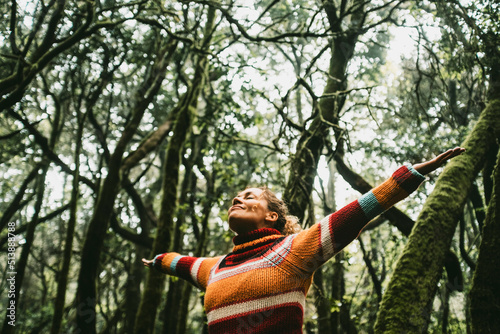Freedom and happiness lifestyle and moment. Standing middle age young woman open arms and smile. Success life and nature feeling. Outdoors nature lover. Protect woods and sustainabiliy future