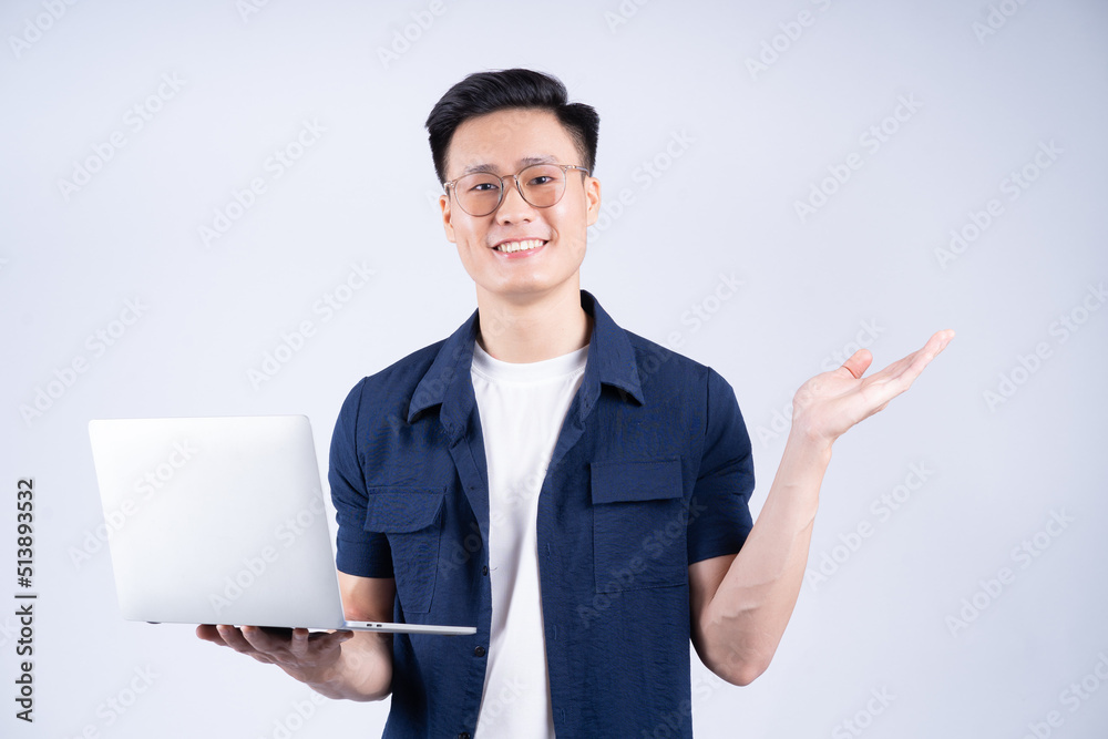 Young Asian man using laptop on white background Young Asian man using laptop on white background