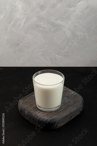 Ayran or Kefir on grey background. Vertical orientation. Fermented sour milk. Buttermilk made with yogurt. Milk diet for weight loss