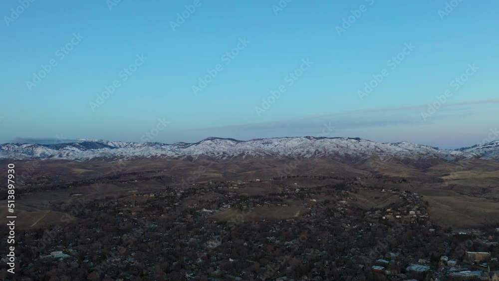 Morning drone shot over Boise, Idaho with snow capped mountains in the background. Morning drone shot over Boise, Idaho with snow capped mountains in the background.