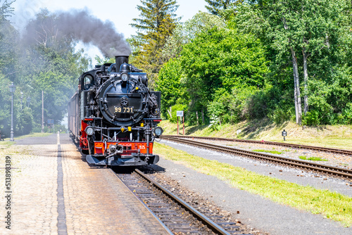Old steam locomotive on narrow-gauge railwaytrack