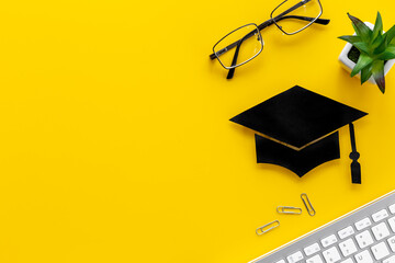 Academic cap or graduation hat on students desk. Education concept