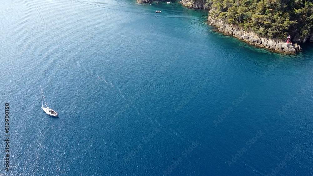 Drone aerial view of sailing boat sails in the open sea of blue color ...
