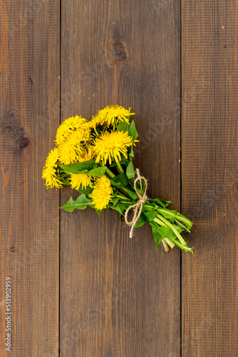 Small posy of yellow dandelions blossoms. Summer floral background