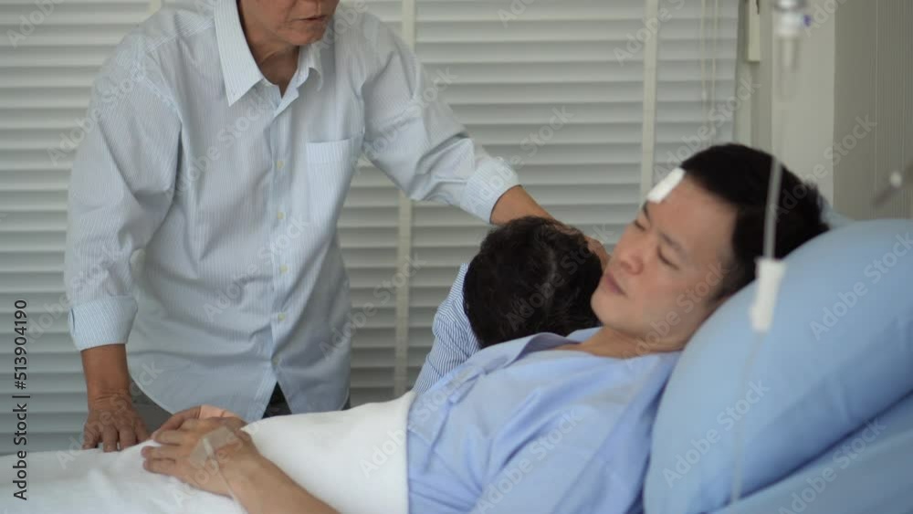 Asian elderly parents crying at hospital bed worry son condition after accident fatal physical injured