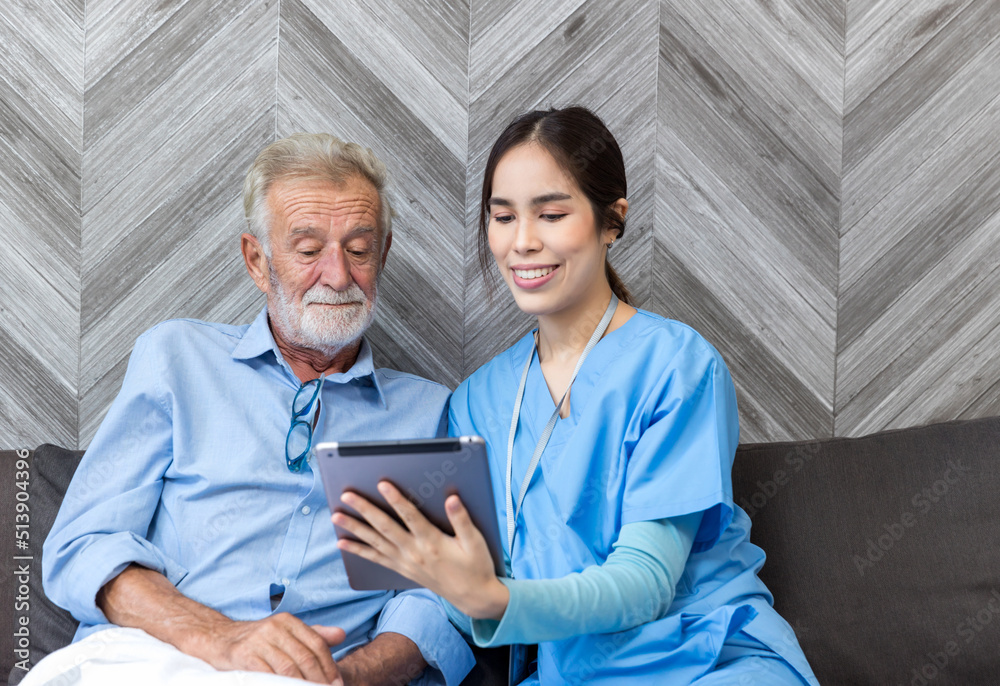 Nurse helping patient for using tablet. Caretaker and senior man using tablet PC at nursing home Nurse helping patient for using tablet. Caretaker and senior man using tablet PC at nursing home