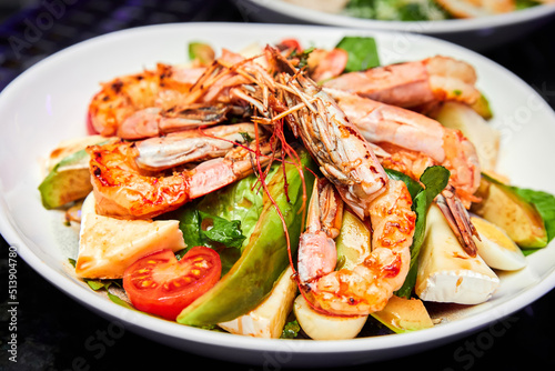 Salad with avocado, tiger prawns, tomatoes and quail eggs