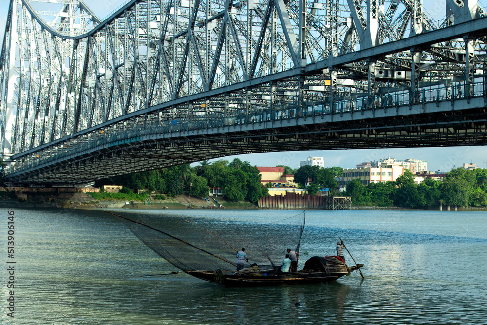 iconic Howrah bridge or Rabindra Setu  of Kolkata and boat in river Ganges 