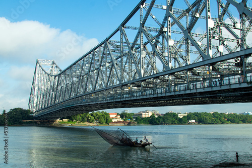 iconic Howrah bridge or Rabindra Setu  of Kolkata and boat in river Ganges 