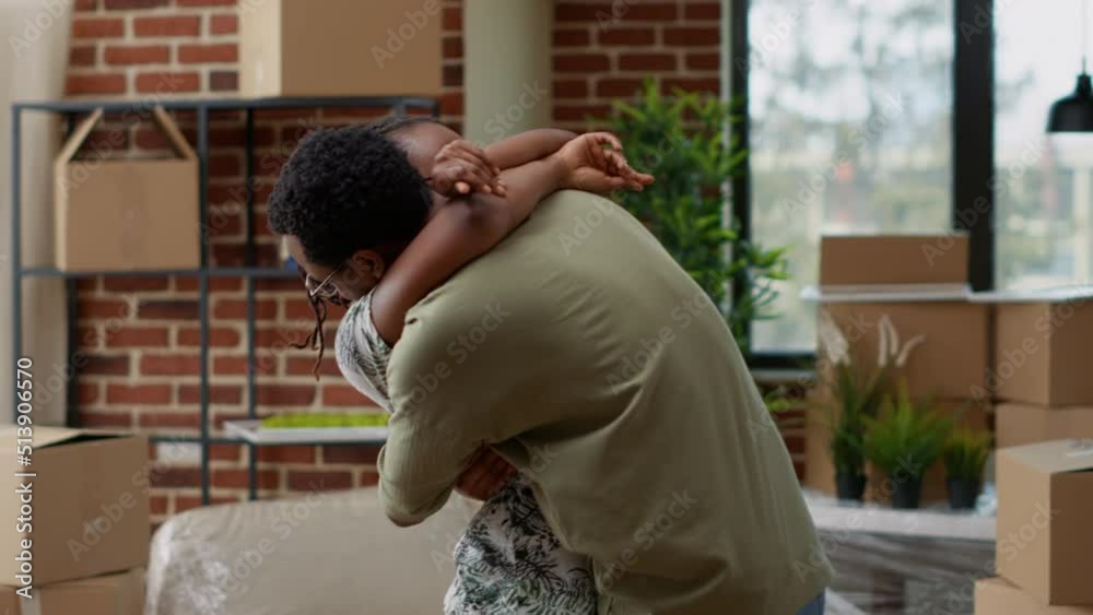 Husband and wife hugging each other and celebrating life event, buying apartment on mortgage loan to move in together. Sharing embrace, enjoying family home relocation. Handheld shot. Husband and wife hugging each other and celebrating life event, buying apartment on mortgage loan to move in together. Sharing embrace, enjoying family home relocation. Handheld shot.