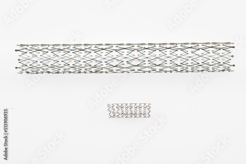 Stent and catheter for implantation into blood vessels with an empty and filled balloon. Metal stent for implantation and supporting blood circulation into blood vessels. High resolution photography. photo