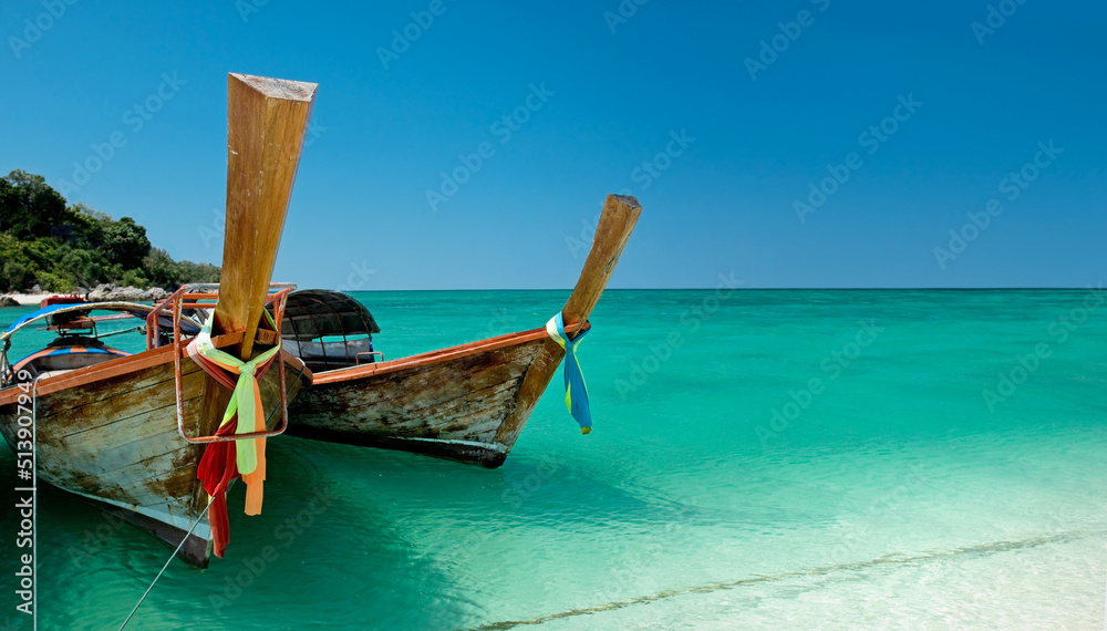 Shot of a boat docked on the shore on a beach in Phuket Thailand Shot of a boat docked on the shore on a beach in Phuket Thailand