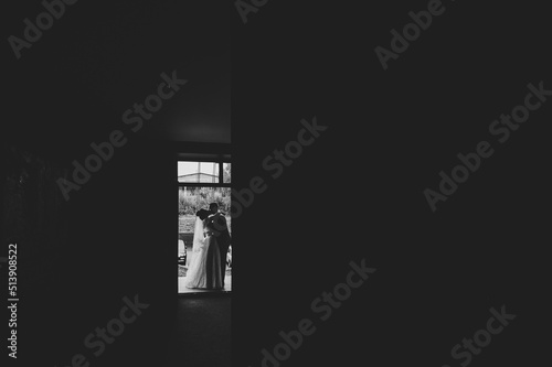 Fotobehang The bride and groom near window