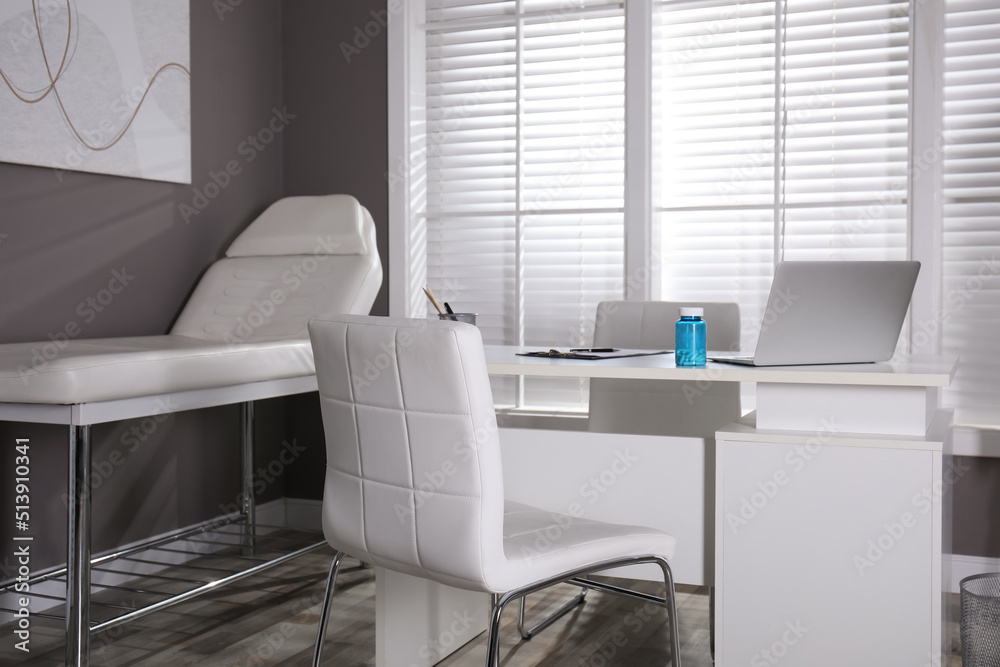 Modern medical office interior with doctor's workplace and examination ...