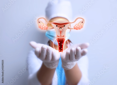 Doctor demonstrating virtual image of infected female reproductive system on light background, closeup. Vaginal candidiasis photo
