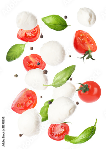 Mozzarella cheese balls  tomatoes  basil leaves and peppercorns for caprese salad flying on white background